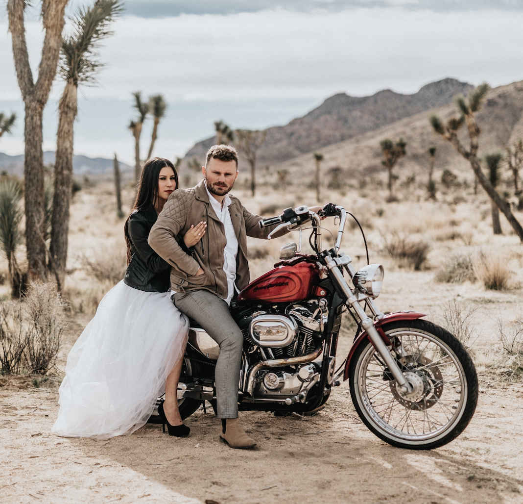 groom and bride on a motorcycle in the desert